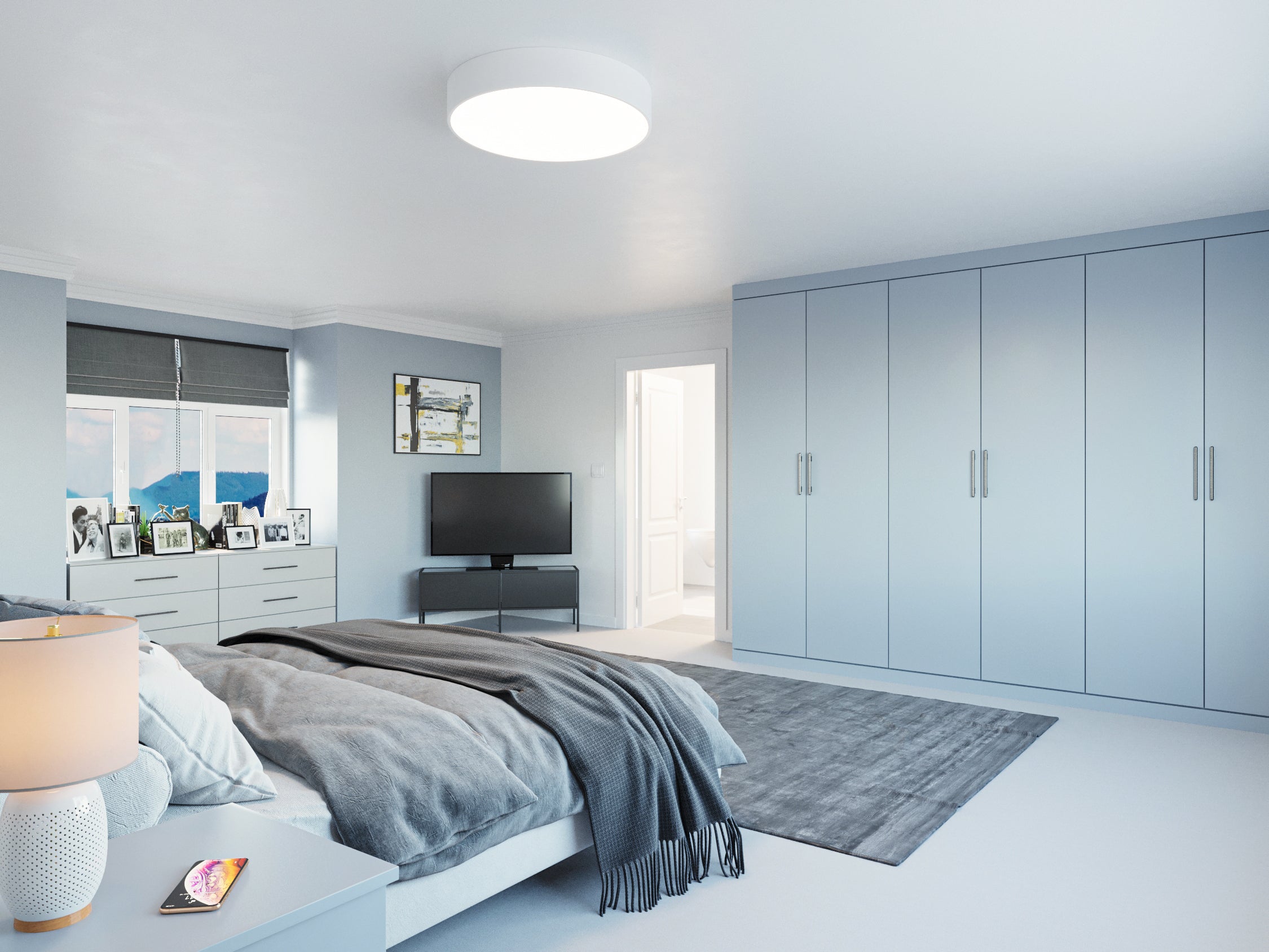 Light blue fitted wardrobe in a bedroom across one wall