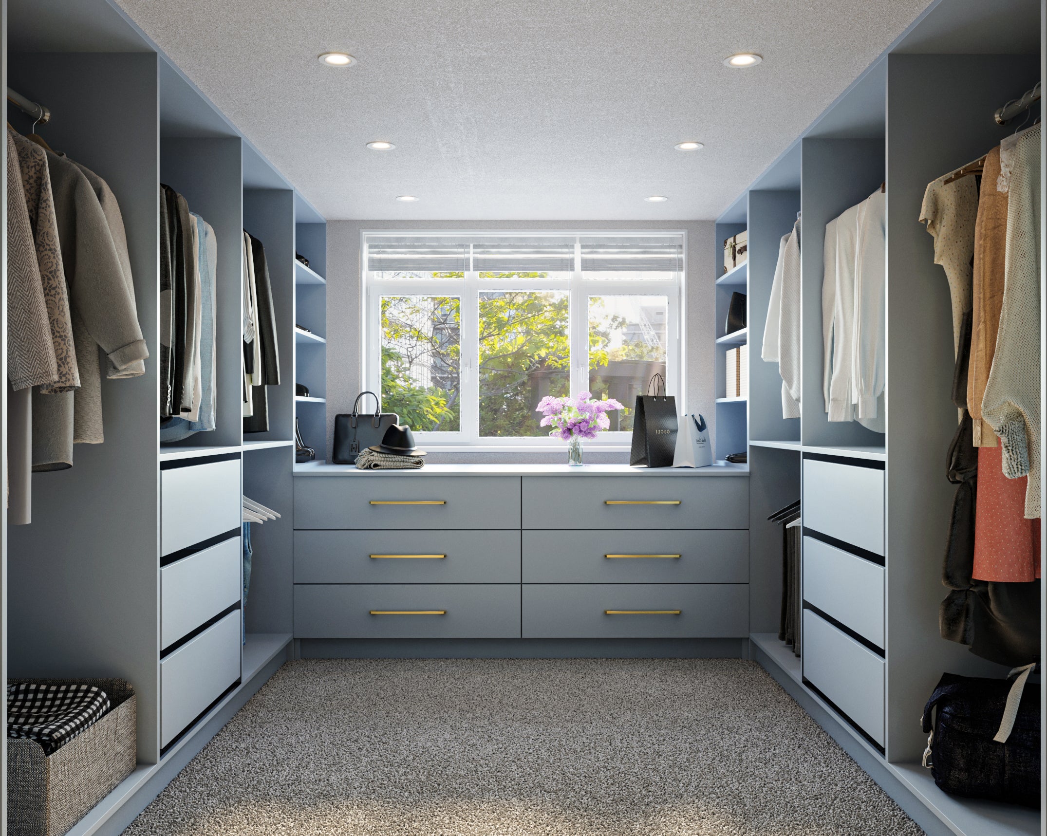 light blue walk-in wardrobe with central drawer unit and wardrobes on either side displaying hanging clothes