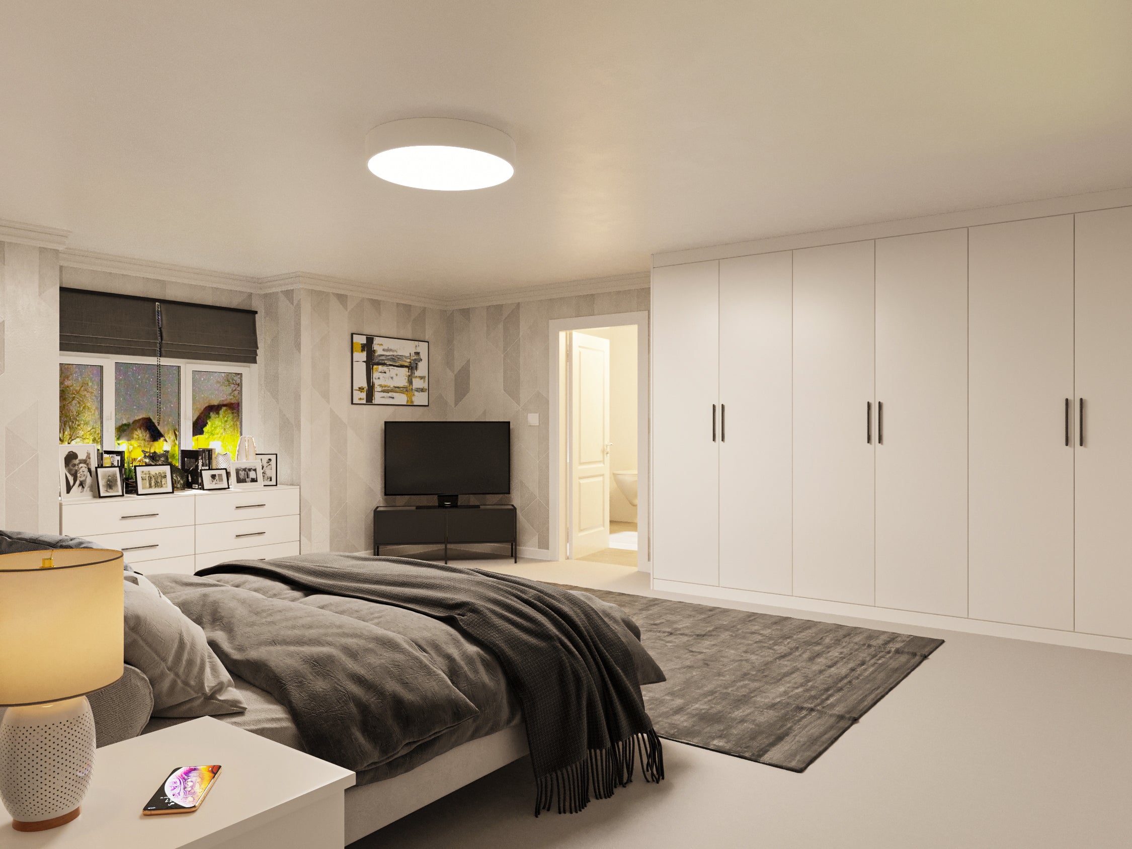 White fitted wardrobe opposite a bed