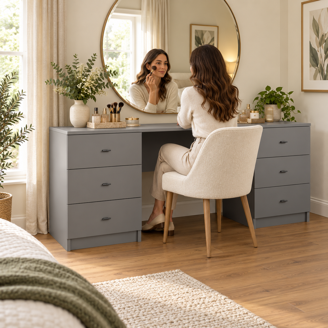 Illustrative matt-grey dressing table with a mirror, chair and woman applying make-up