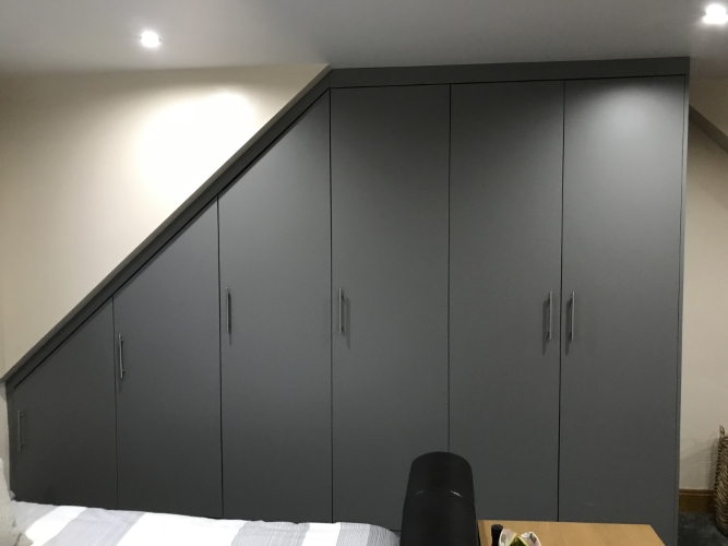 Sloping grey fitted wardrobe