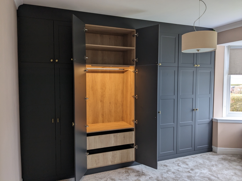 Traditional fitted wardrobe with door open